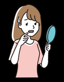 鏡で歯をチェックする女性